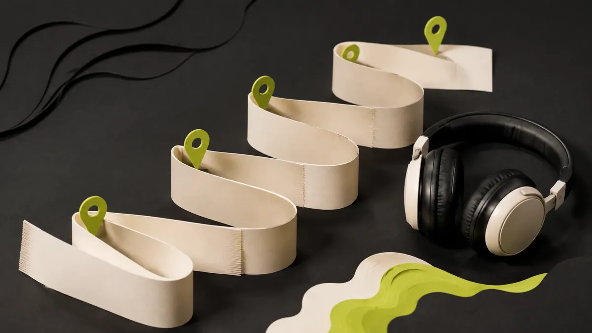Folded rehearsal map with markers beside headphones