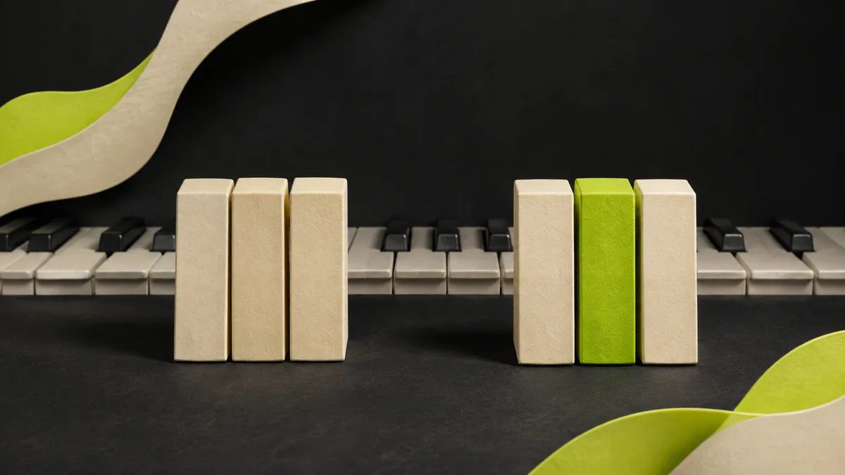 Two sculptural three-note clusters beside piano keys, with a lime middle block highlighting the changing third.