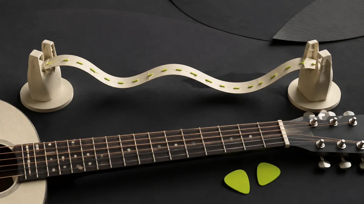 A guitar neck and lime picks beside sculptural chord-shape landmarks joined by a beat bridge.